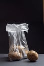 Potatoes in a plastic bag on a dark background. The image shows the harmful effects of plastic bags on food