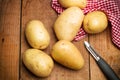 Potatoes and a potatoe peeler Royalty Free Stock Photo