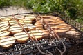 Potatoes with sausages on hot coals, the process of cooking outdoors