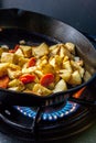 Potatoes in skillet over a fire. Royalty Free Stock Photo