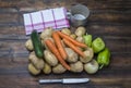 Potatoes and vegetable on the rustic table with knife Royalty Free Stock Photo