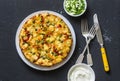 Potatoes and vegetables tortilla on a dark background, top view. Potatoes, green beans, bell peppers, green peas, cheese, eggs cas Royalty Free Stock Photo