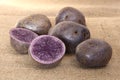 Potatoes `Vitelotte` cut Royalty Free Stock Photo