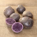 Potatoes `Vitelotte` cut Royalty Free Stock Photo