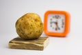 Potatoes on a white background regain the clock