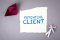 POTENTIAL CLIENT. Text on note sheet and paper boat on a gray background