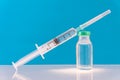 Potential trials stage concept on blue background. Close up Vials with sterile needle syringe. Research and Development, Royalty Free Stock Photo