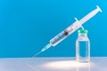 Potential trials stage concept on blue background. Close up Vials with sterile needle syringe. Research and Development, Royalty Free Stock Photo