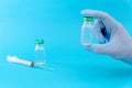 Potential trials stage concept on blue background. Close up Vials with sterile needle syringe. Research and Development, Royalty Free Stock Photo