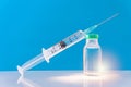 Potential trials stage concept on blue background. Close up Vials with sterile needle syringe. Research and Development, Royalty Free Stock Photo