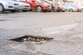 pothole with water after rain on asphalt roadway Royalty Free Stock Photo