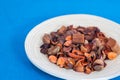 Potpourri Close-up view in the wooden plate with blue background