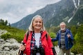 Potrait of active senior woman hiking with husband in autumn mountains. Royalty Free Stock Photo