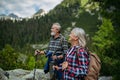 Potrait of active senior woman hiking with husband in autumn mountains. Royalty Free Stock Photo