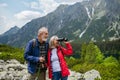 Potrait of active senior woman hiking with husband in autumn mountains. Royalty Free Stock Photo