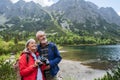 Potrait of active senior woman hiking with husband in autumn mountains. Royalty Free Stock Photo