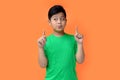 potrait asian boy with happy expression isolated at orange background.