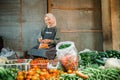 potrait asian seller wrapping fresh vegetable