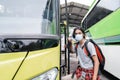 Potrait asian young man wearing face masks getting on the bus