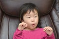Cute little girl making funny faces into the camera Royalty Free Stock Photo