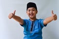 potrait of handsome asian muslim boy with thumbs up expression