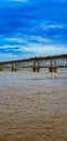 Potrait image of flooded Godavari River flows under rail cum road bridge , Rajahmundry, Andhrapradesh