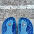 Potrait of a pair blue sandals in front of house this morning Royalty Free Stock Photo
