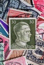 Potsdam, Germany - APR 26, 2022. A stack of old German stamps from the Third Reich and on it a stamp with printed portrait of Royalty Free Stock Photo