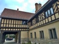 Potsdam / Germany - March 24 2018: Side part of the palace Cecilienhof. A group of tourist is listening to a guide in the distance