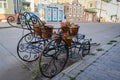 Potted flowers on a wrought iron stand in the form of an old carriage on the street in Kazan, Russia