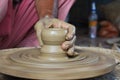 Potter creating pot using clay