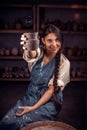 Potter female admires the work done in a pottery workshop. Pottery workshop. Royalty Free Stock Photo