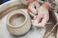 Potter make a decorative pattern on pot