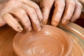 Potter makes pottery dishes on potter`s wheel