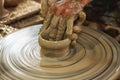 Potter makes on the pottery wheel