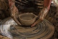 Potter makes on the pottery wheel