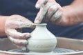 Potter making ceramic pot on the pottery wheel