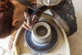 Potter making ceramic pot or vase on pottery wheel