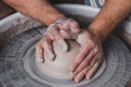 Potter making a new vase of white clay on the potter`s wheel circle in studio, concept of manual work, creativity and art, Royalty Free Stock Photo