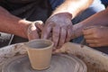 A potter craftsman transfers his skills to a student