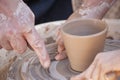 A potter craftsman transfers his skills to a student