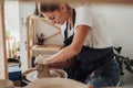 Potter Master at Work, Young Caucasian Woman Creating Clay Pot on a Pottery Wheel in Her Studio Royalty Free Stock Photo
