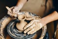 Potter modeling ceramic pot from clay on a potter`s wheel Royalty Free Stock Photo