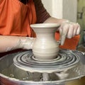 Potter modeling ceramic pot from clay on a potter's wheel. Royalty Free Stock Photo