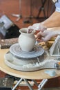 The Potter molds a pot from clay on a Potter`s wheel. The master`s hands make a pot on the potter`s wheel. vertical Royalty Free Stock Photo