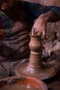 The potter`s hand shapes the clay pitcherlying on the spinning potter`s wheel