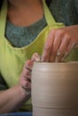 Potter`s hands making a clay pot on pottery
