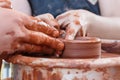 On the potter`s wheel revolve a clay cup. Royalty Free Stock Photo