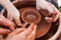 On the potter`s wheel revolve a clay cup. Royalty Free Stock Photo