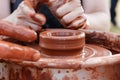 On the potter`s wheel revolve a clay cup. Royalty Free Stock Photo